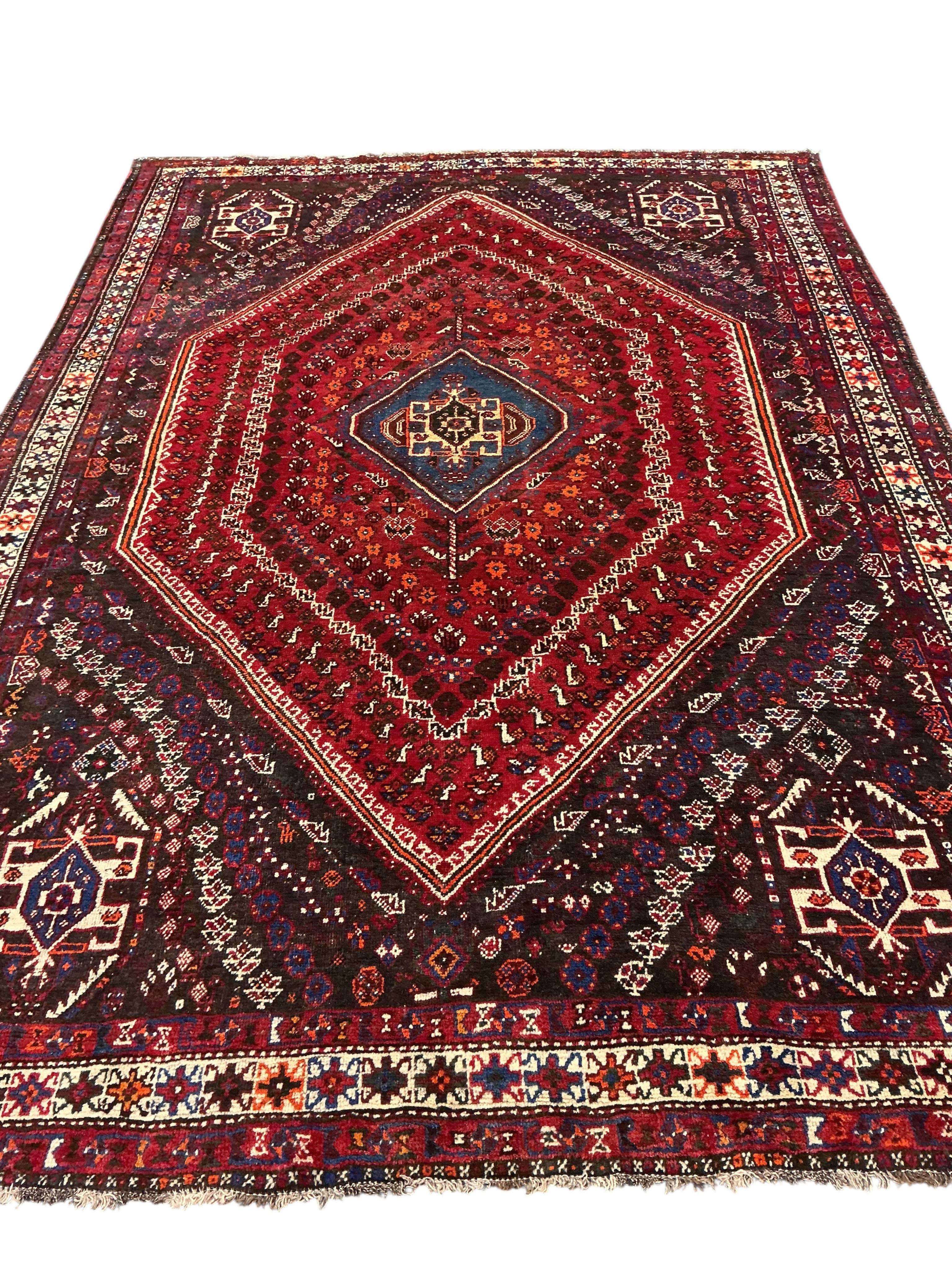 A Hamadan red ground carpet, 305 x 220cm.